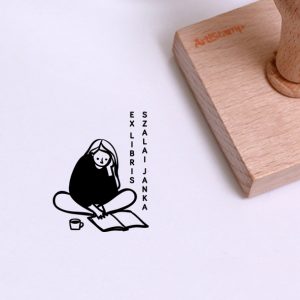 Ex libris pecsét, törökülésben ülő és olvasó lányt ábrázoló grafikával. Nyeles fa alapra készült, gumi lenyomattal, egyedileg megadott névvel készült.